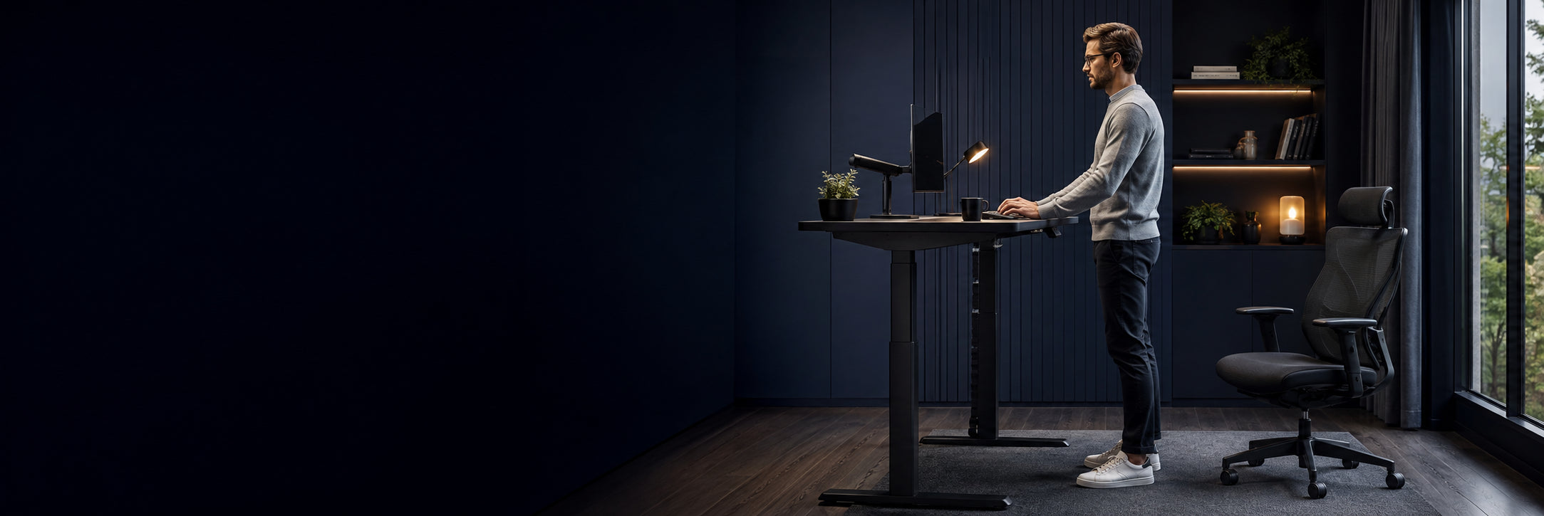 Professional working at a Furnitech height-adjustable standing desk in a modern home office